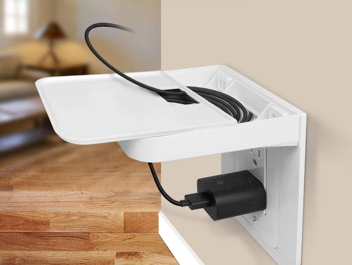 A small shelf mounted above an electrical outlet