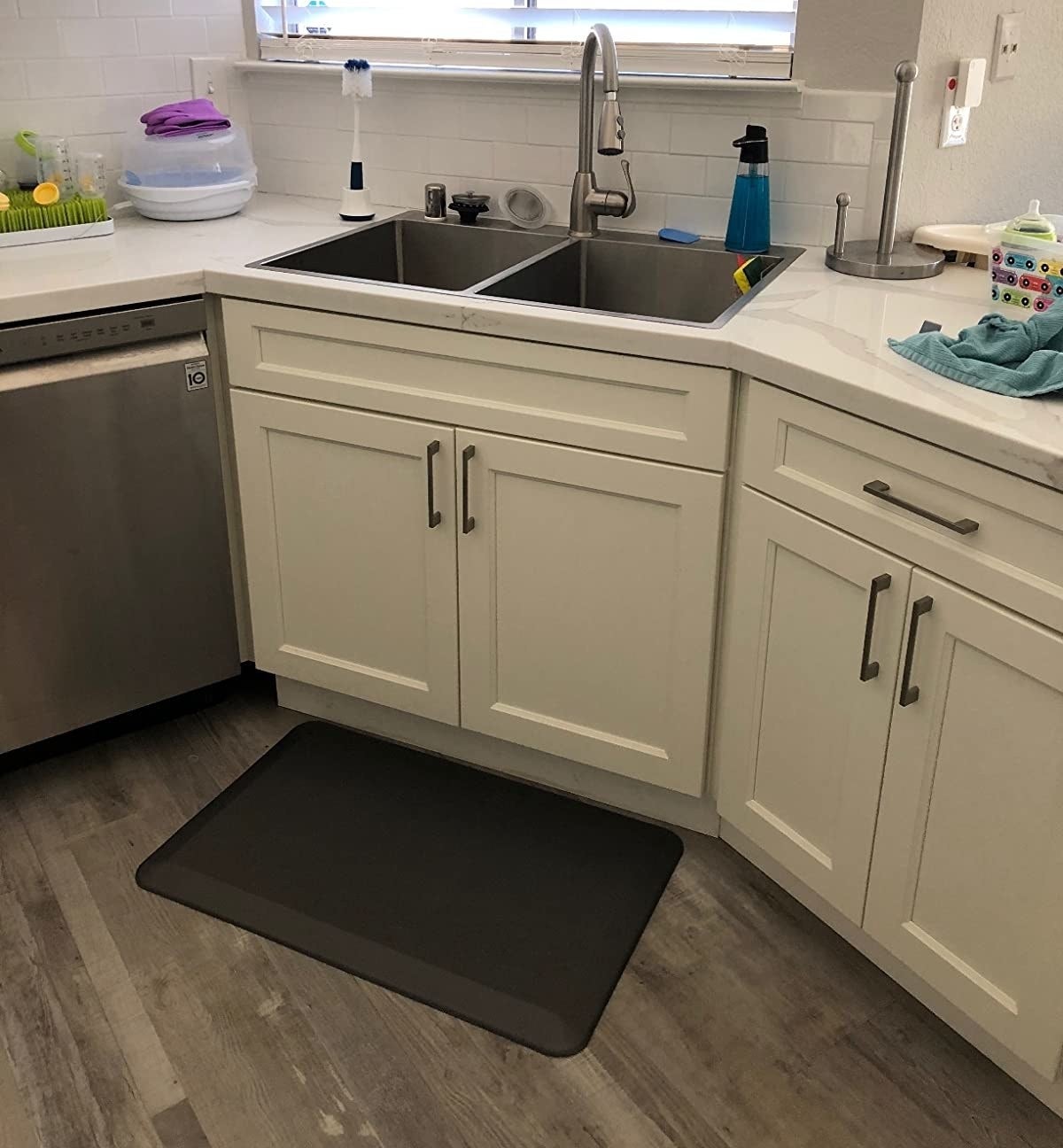 reviewer image of black anti-fatigue mat in front of kitchen sink
