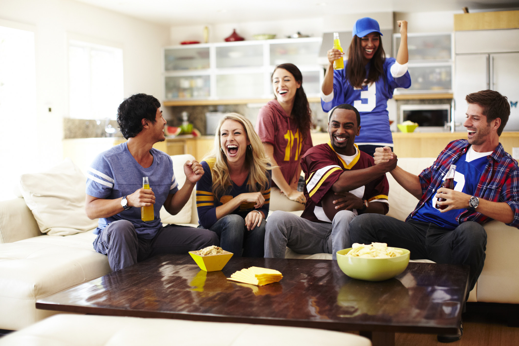 Friends celebrating while watching the game