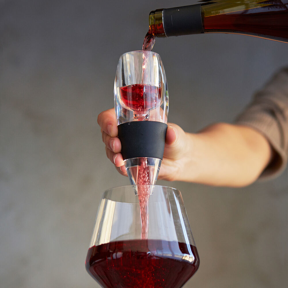 Model pouring red wine through the aerator and into a glass