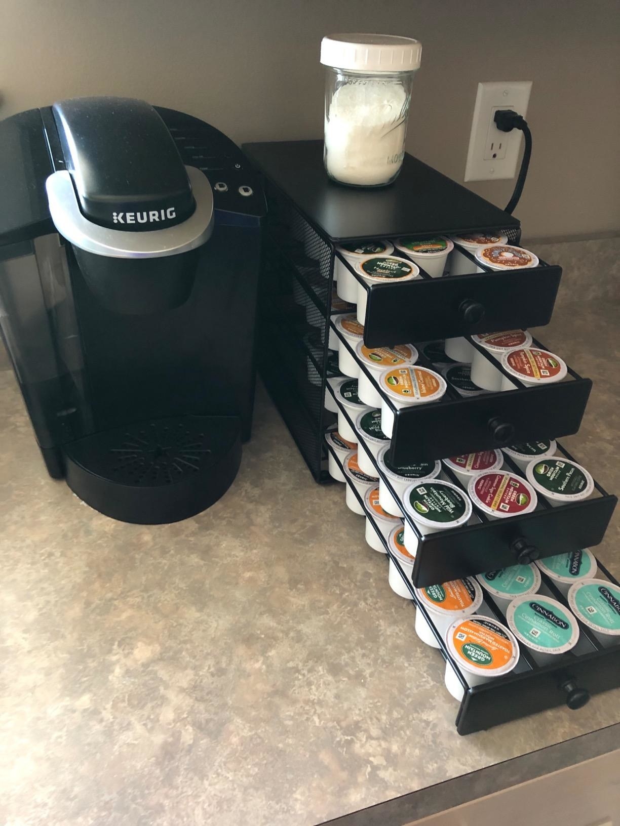 reviewer photo of the four tier drawer displaying a massive collection of coffee pods