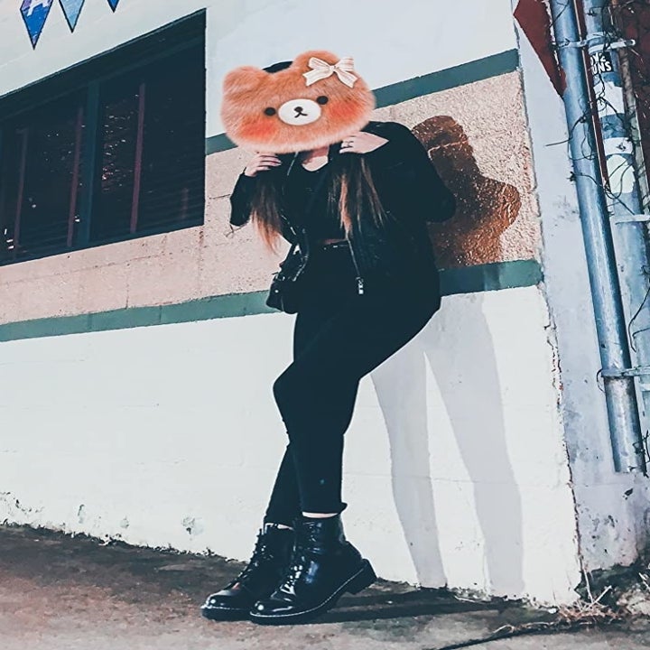 reviewer wearing the black boots with a full black outfit