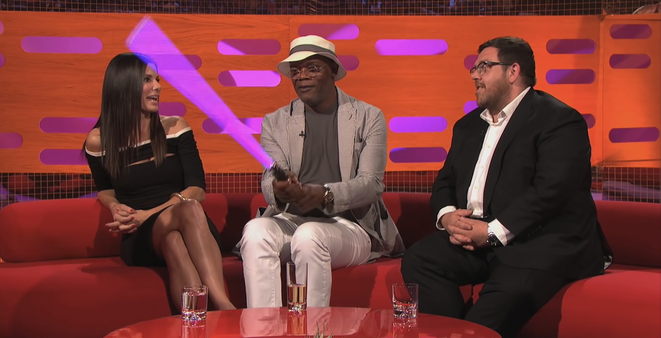 Samuel L. Jackson plays with a purple lightsaber given to him by Graham