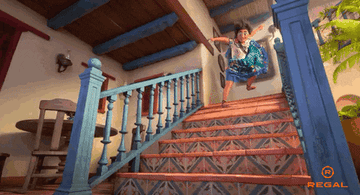 Mirabel from Encanto sliding down the stairs