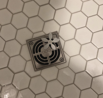 A customer review photo showing the Drainwig in their shower drain