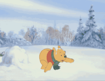 GIF of Winnie the Pooh jumping around in the snow