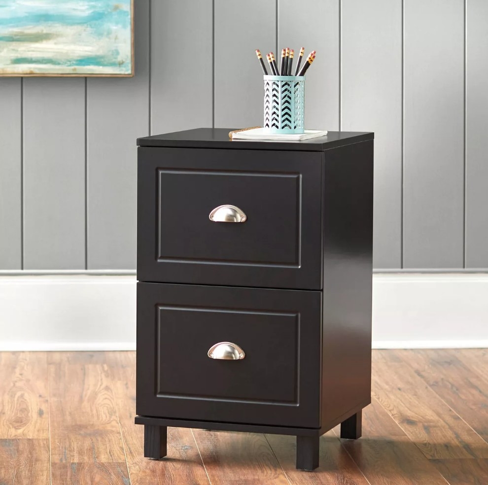 Black two drawer filing cabinet with pencil cup on top