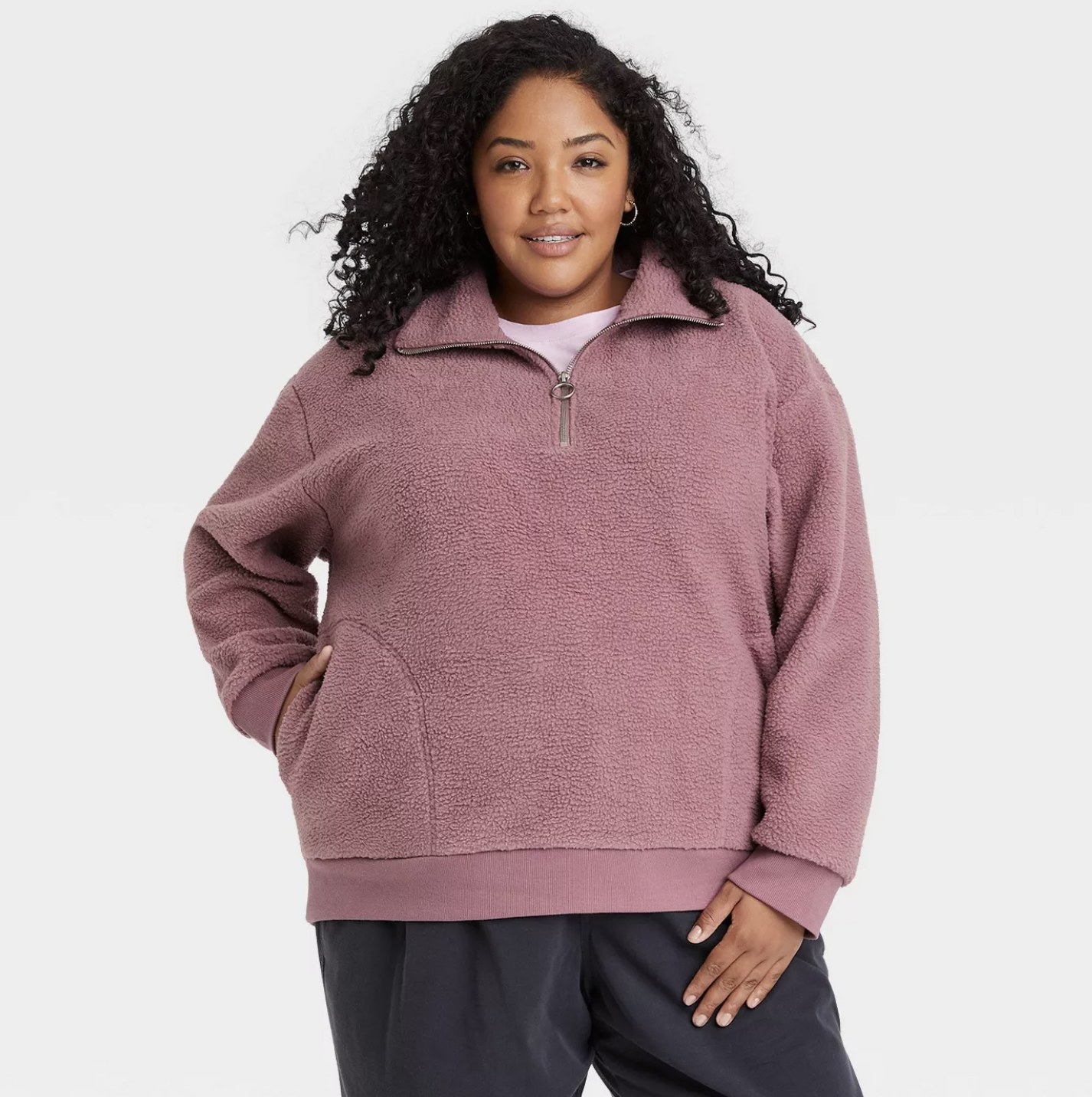 Model wearing the pink sherpa quarter-zip