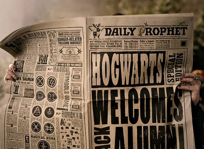 Helena Bonham Carter holding a Daily Prophet newspaper that reads: "Hogwarts Welcomes Back Alumni"
