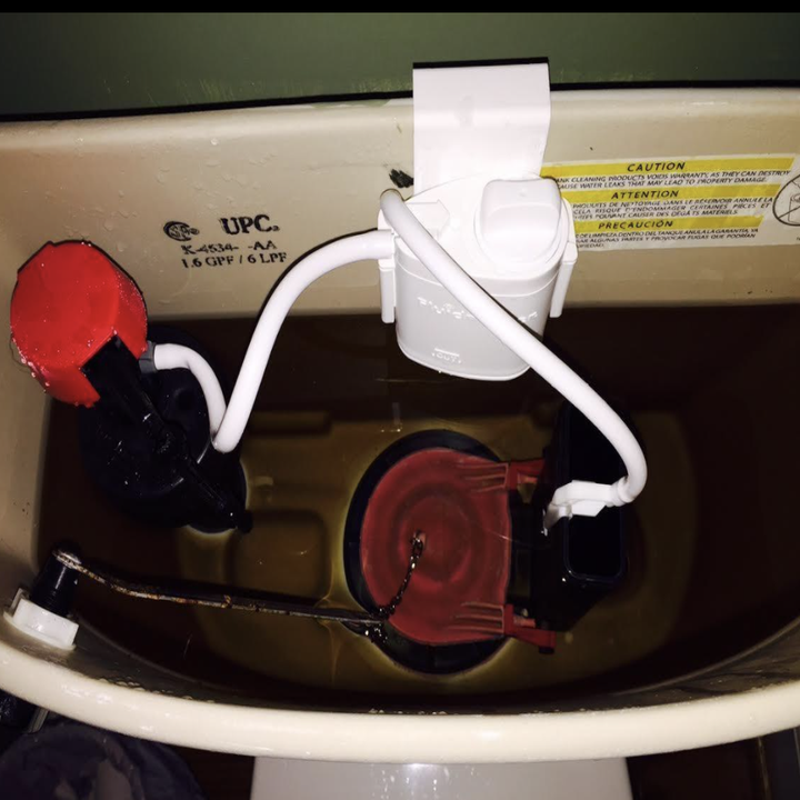 reviewer image of flush 'n sparkle kit in water tank of toilet