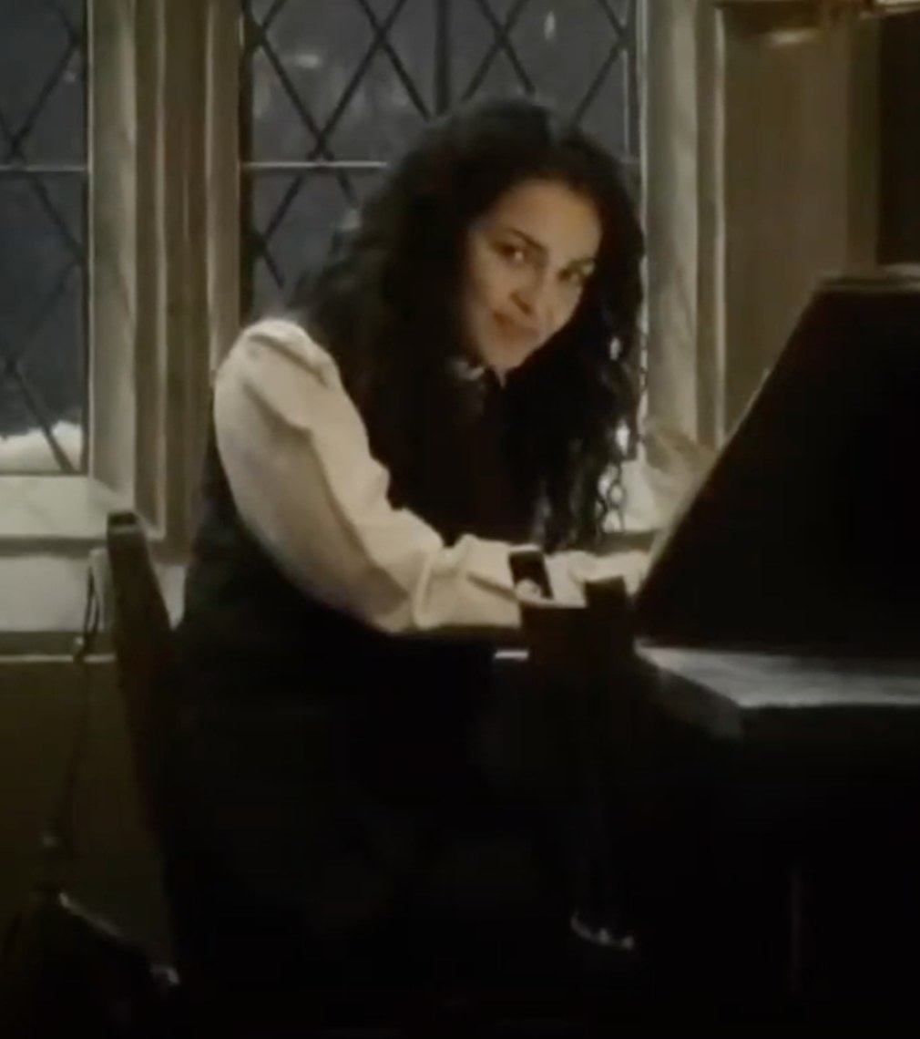 Anna Shaffer as Romilda Vane admiring Harry Potter from a distance