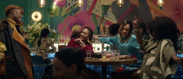 Four friends are dancing and having fun while at a restaurant