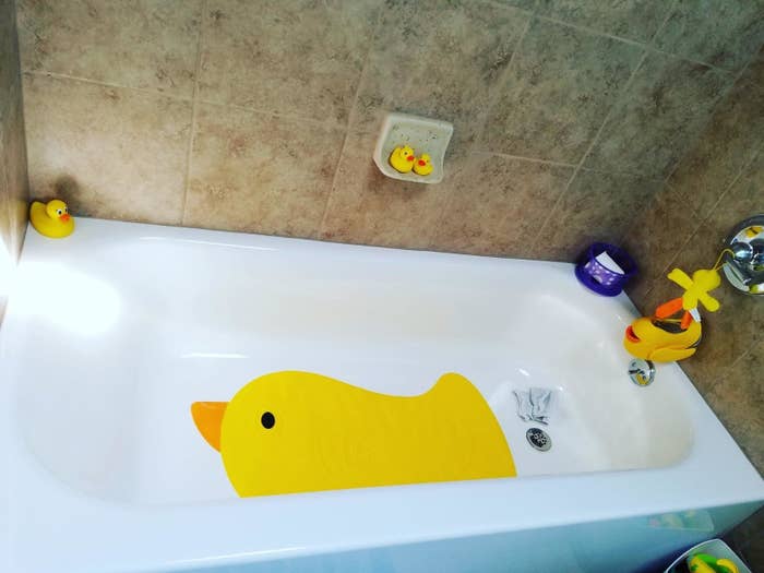 reviewer&#x27;s photo of the duck shaped bath bat in their tub