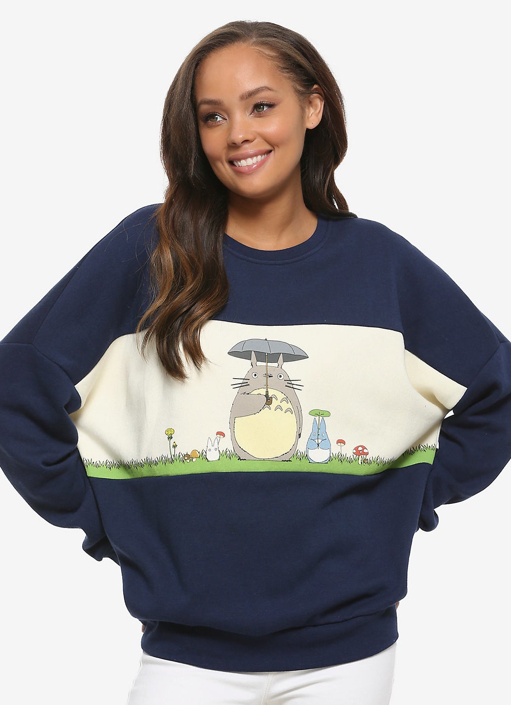 a model in a navy sweatshirt with a scene from my neighbor totoro on it