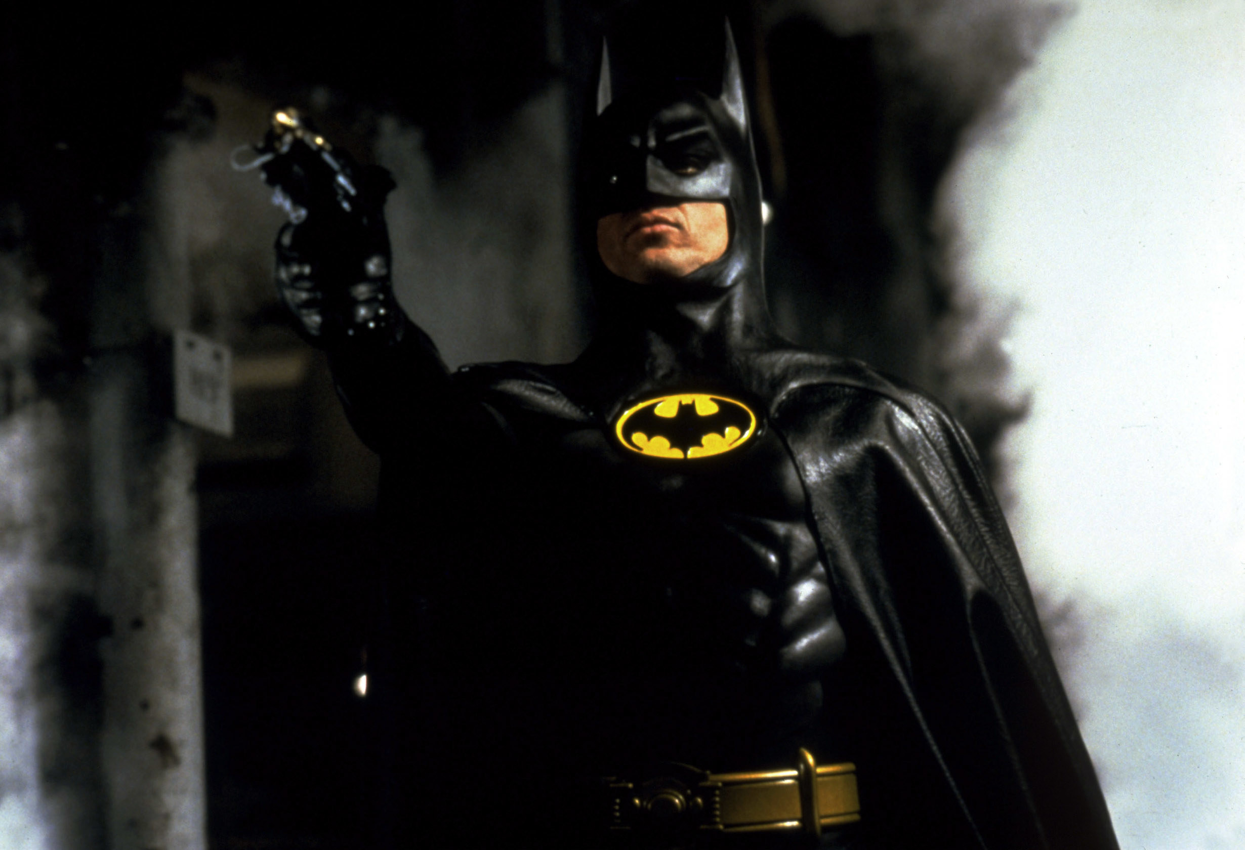 Batman points his Bat device in the distance