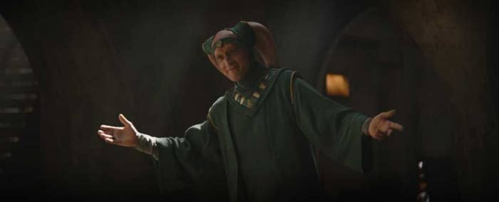 Red Male Twi'lek bows and smiles