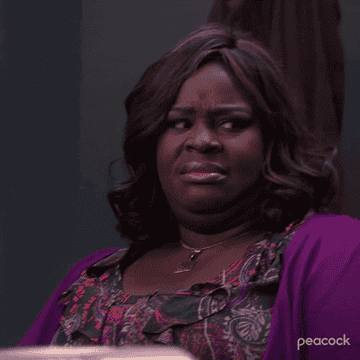 Donna stares then looks away uncomfortably while frowning on Parks and Rec