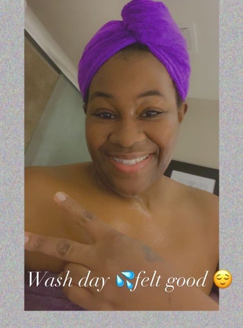 a reviewer wearing the purple towel with a text caption that reads 