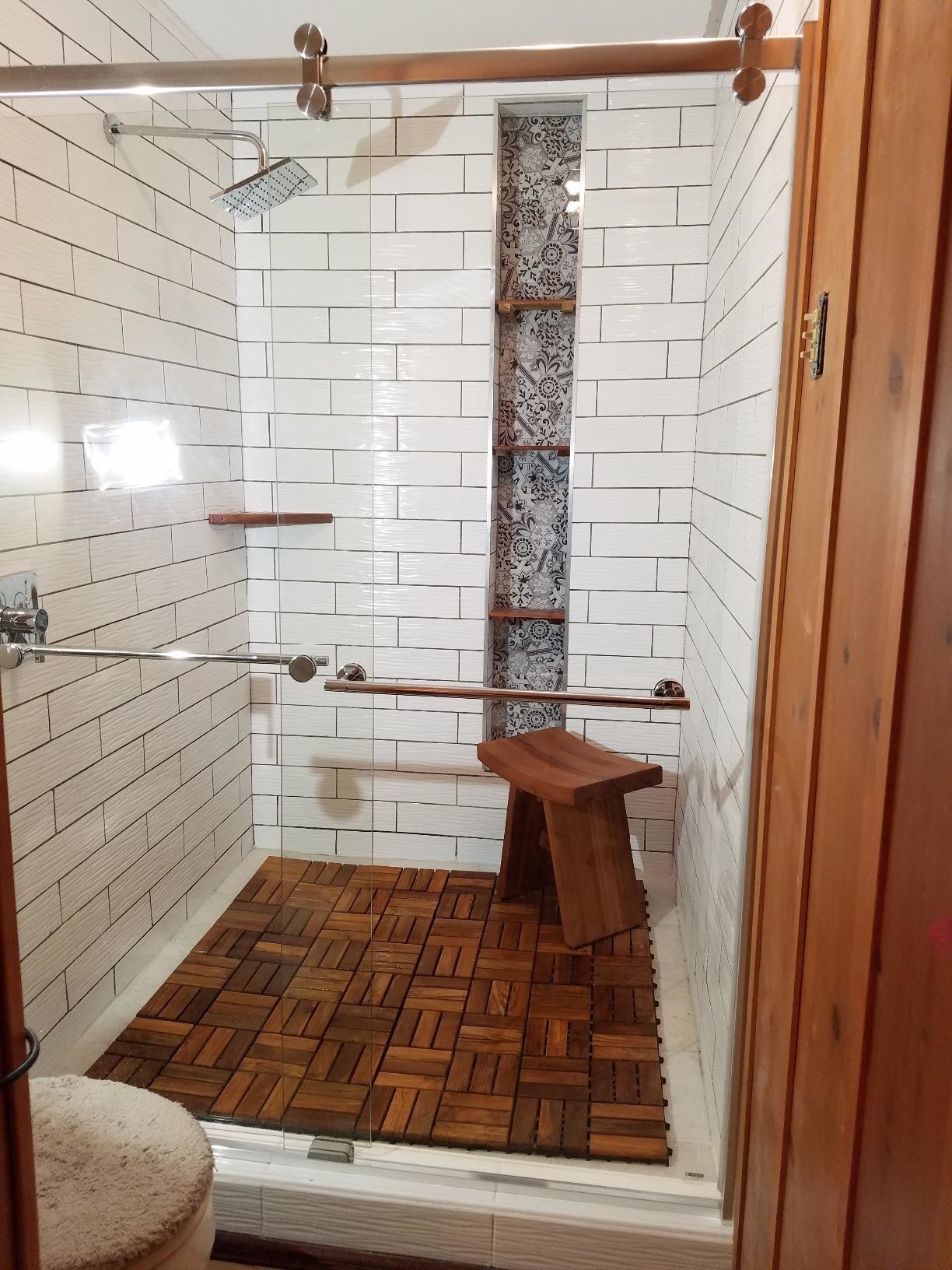 Reviewer&#x27;s shower in with the tiles on the bottom