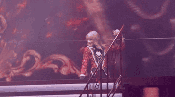 Taylor disappearing and waving off stage.