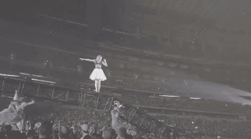 Taylor on a lift device on stage.