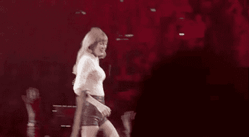 Taylor giving high fives from the stage.