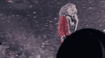 Taylor walking on stage as confetti falls.