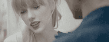 Taylor looking up to an out of view man from the song&#x27;s MV.