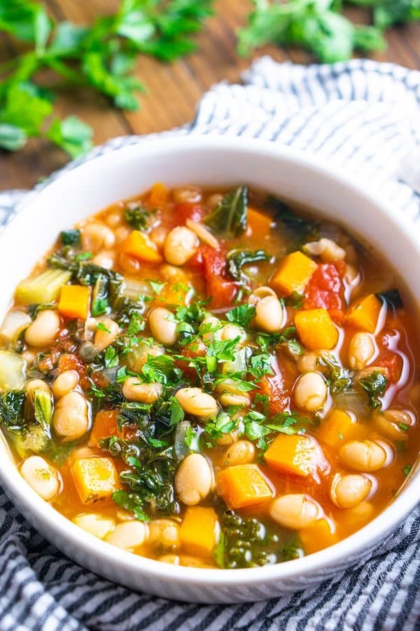 A bowl of white bean and vegetable soup.
