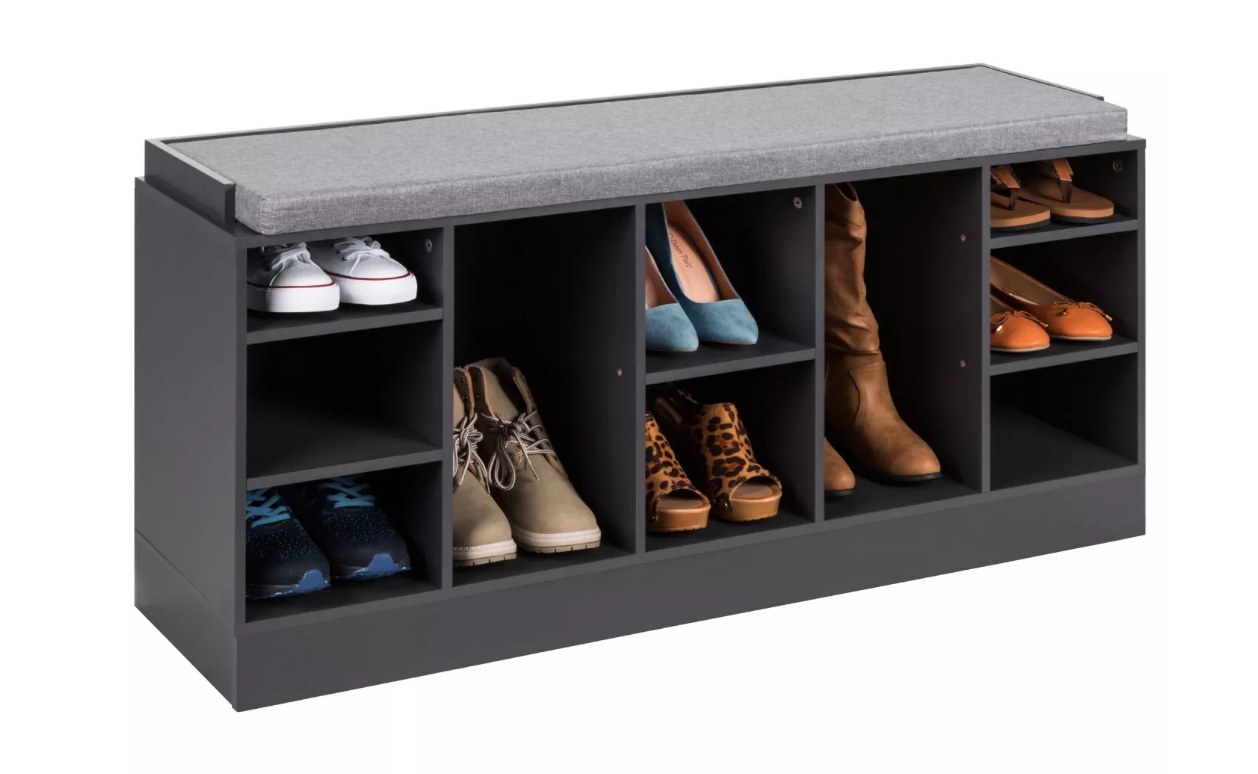 A black shoe storage bench with a grey cushion top
