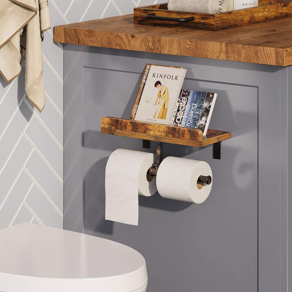 The mounted holder with toilet paper and two books on it
