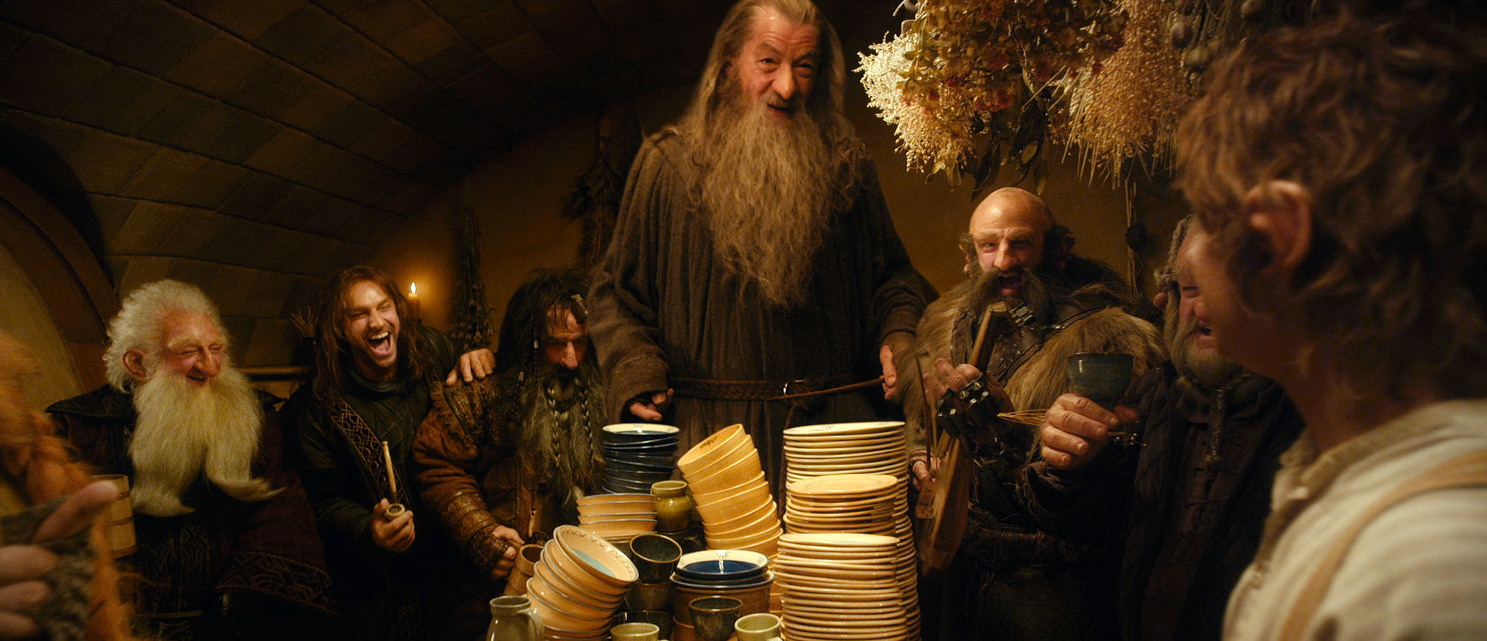 Gandalf laughing with a bunch of hobbits