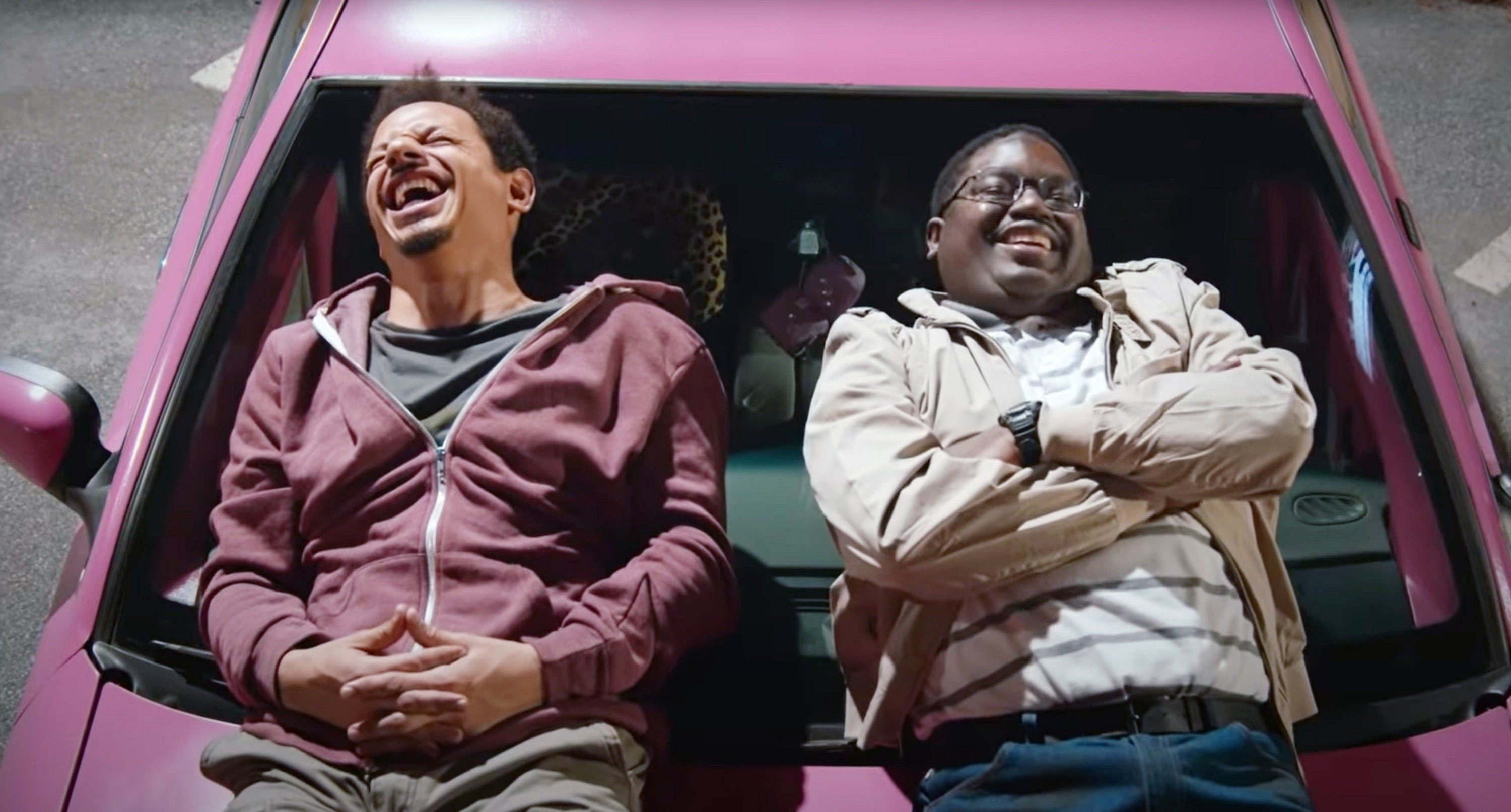 Eric and Lil Rel lying on the hood of their car and laughing
