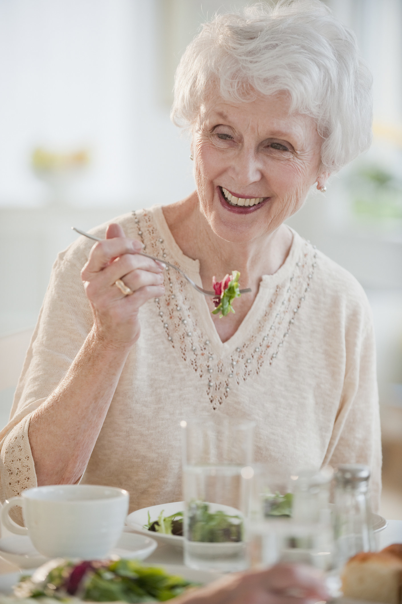 An older woman enjoying a salad