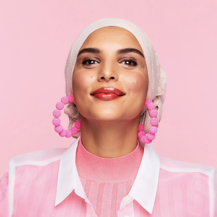 a smiling person wearing the tint on their cheeks and lips