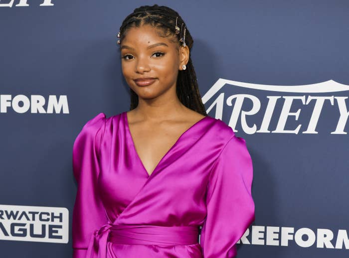 Halle at a red carpet event in a satin wrap dress