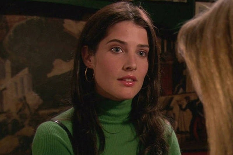 robin wears a turtleneck and hoop earrings, brows and face relaxed