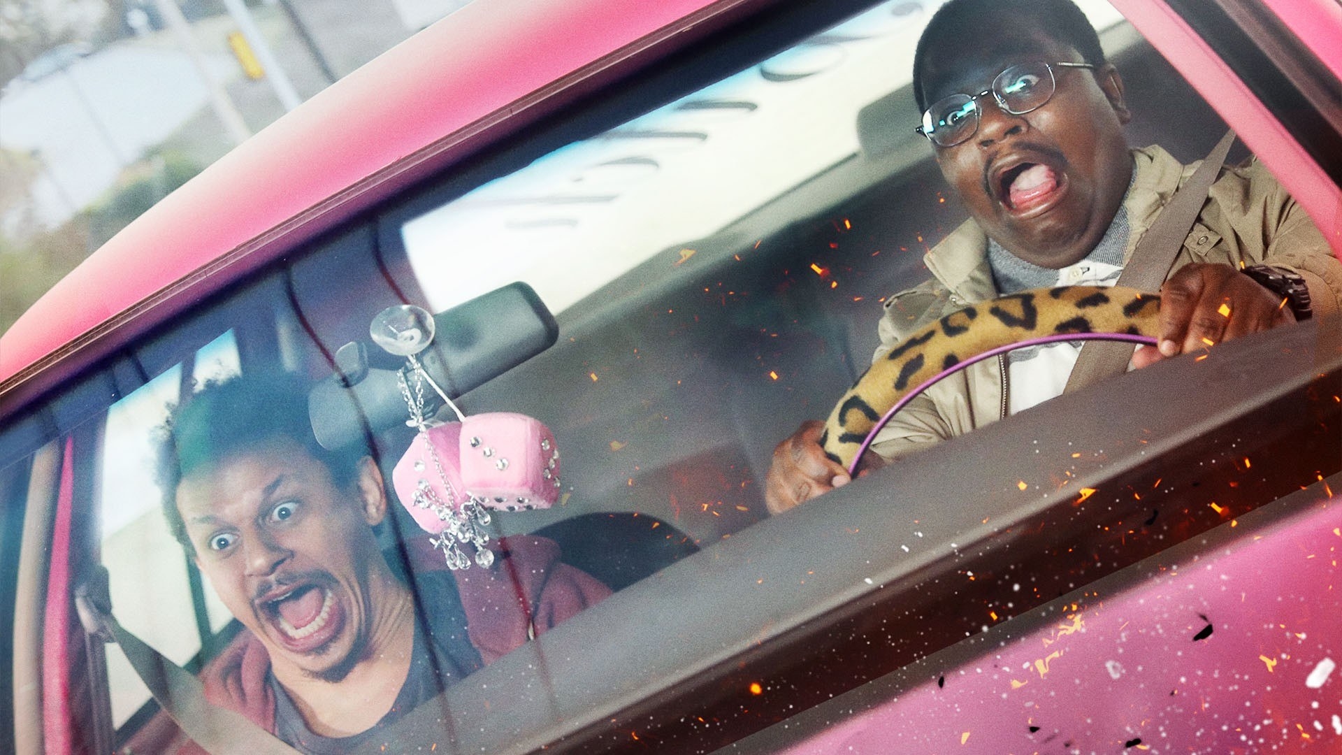 Eric Andre and Lil Rel driving in a bright pink car and screaming