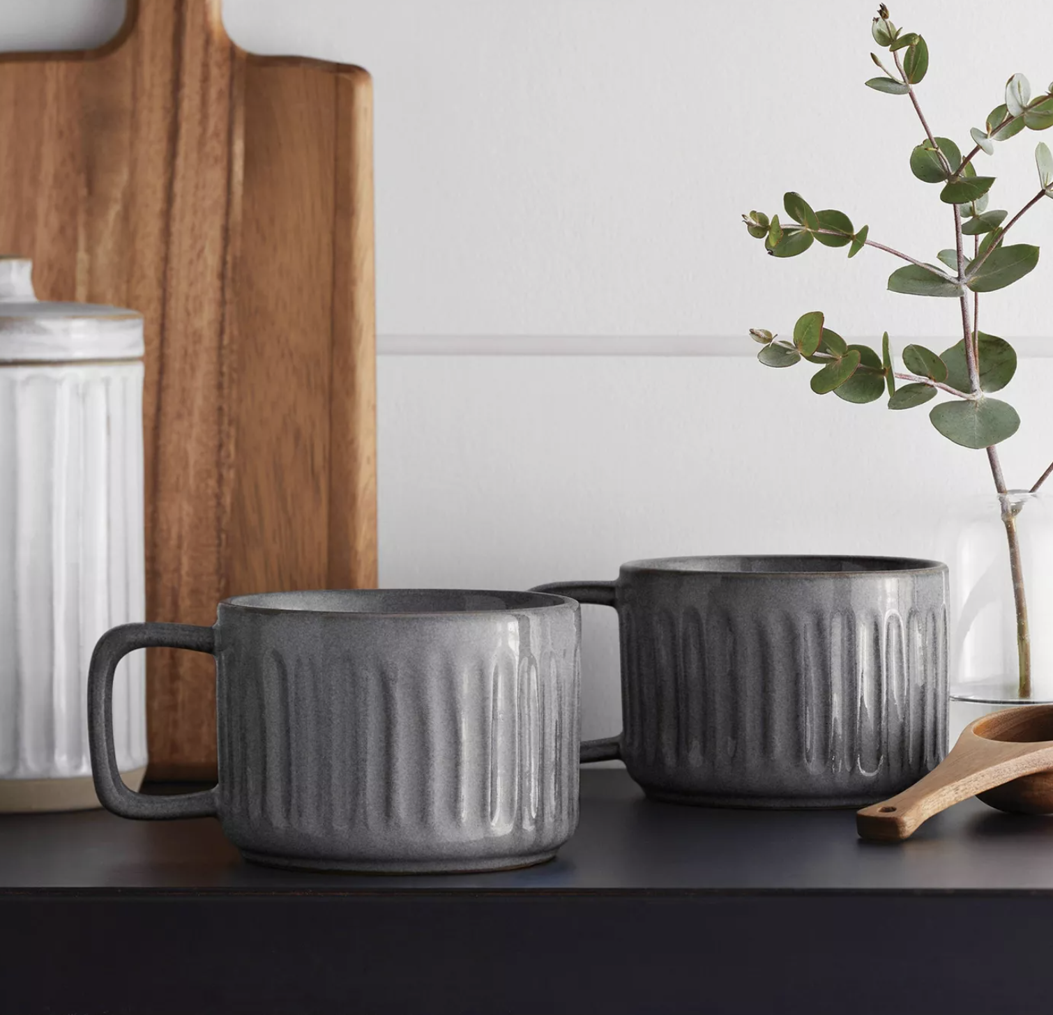 two of the gray stoneware mugs with fluted design