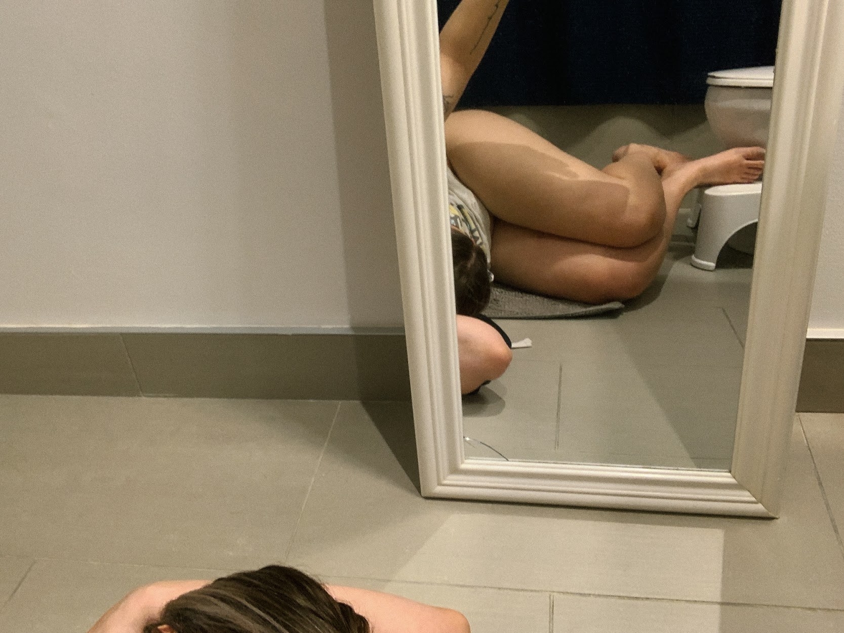 Hannah lying on the bathroom floor in pain