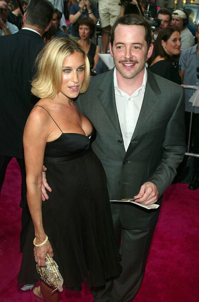 Matthew and Sarah on a red carpet and she's pregnant