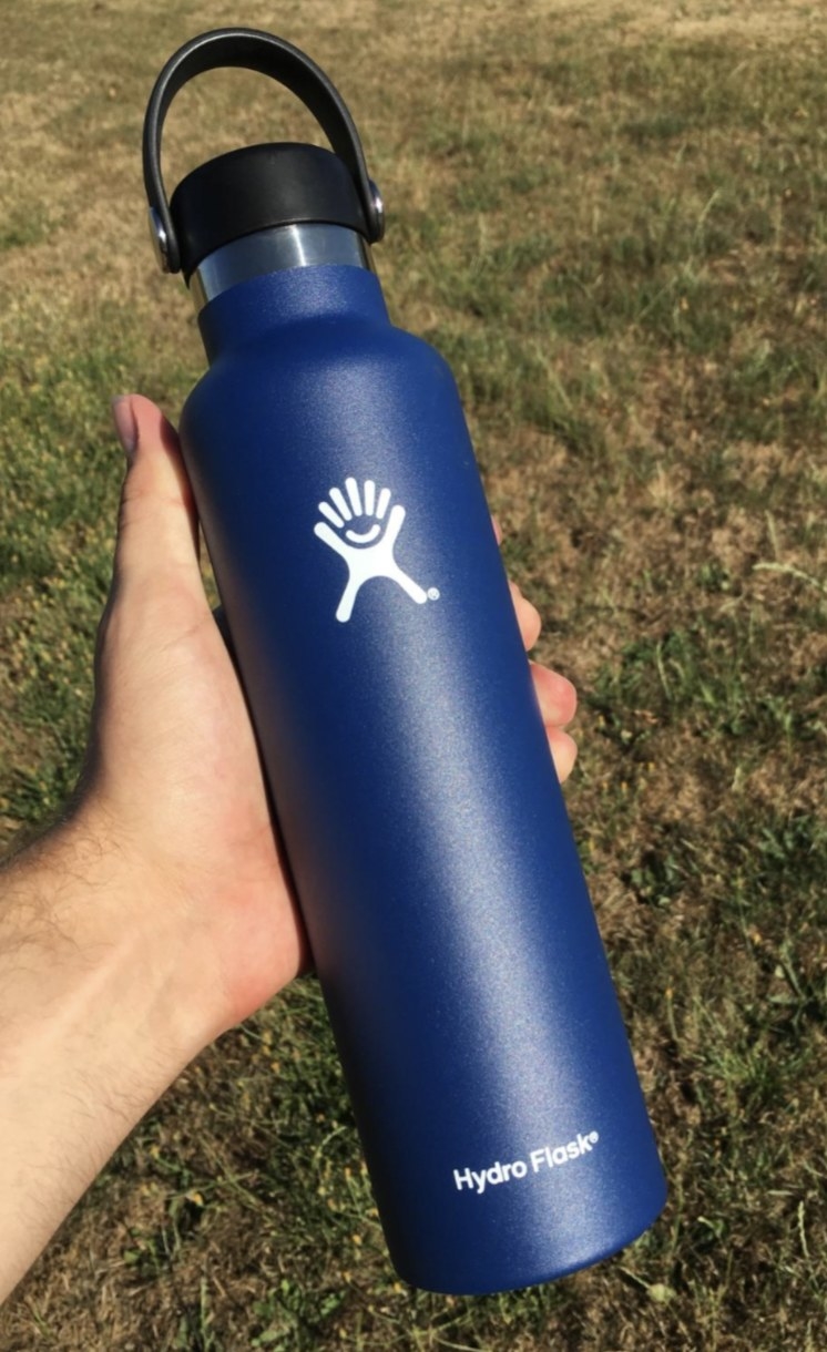 a reviewer holding their navy Hydro Flask
