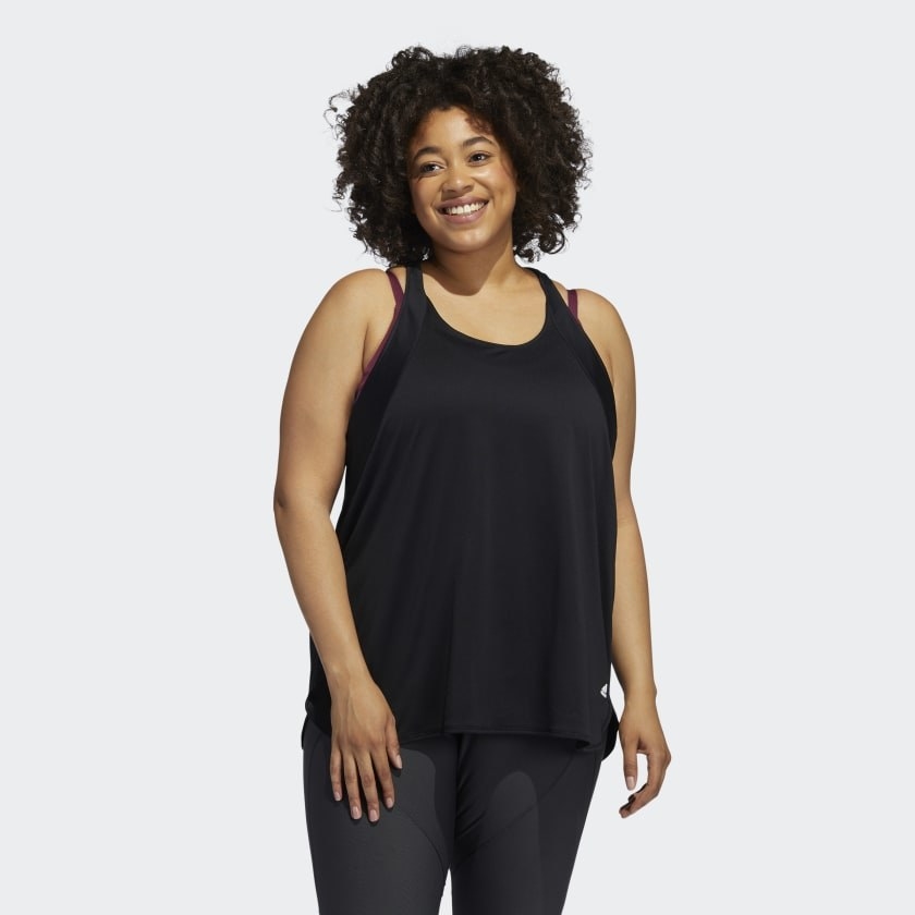 An image of a model wearing a plus-size tank top made with 100 percent recycled polyester