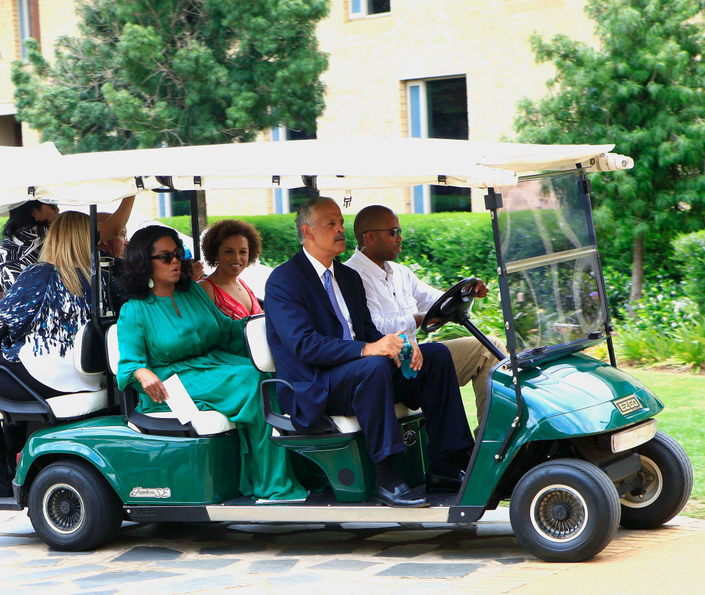 the couple is being carted around on a golf cart