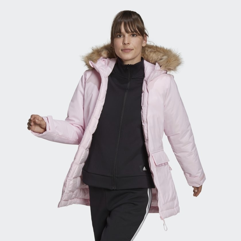 An image of a woman wearing a hooded parka in pink