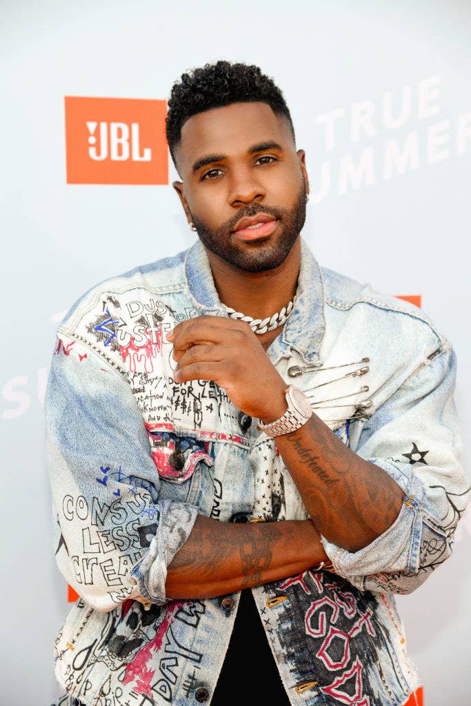 Jason at a red carpet event rocking a distressed and graffitied denim jacket