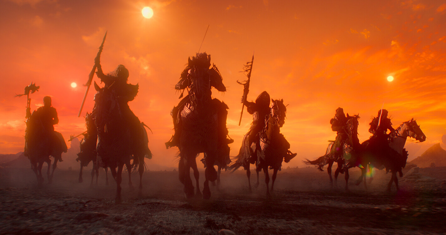 The Wild Hunt ride on horses beneath an orange sky
