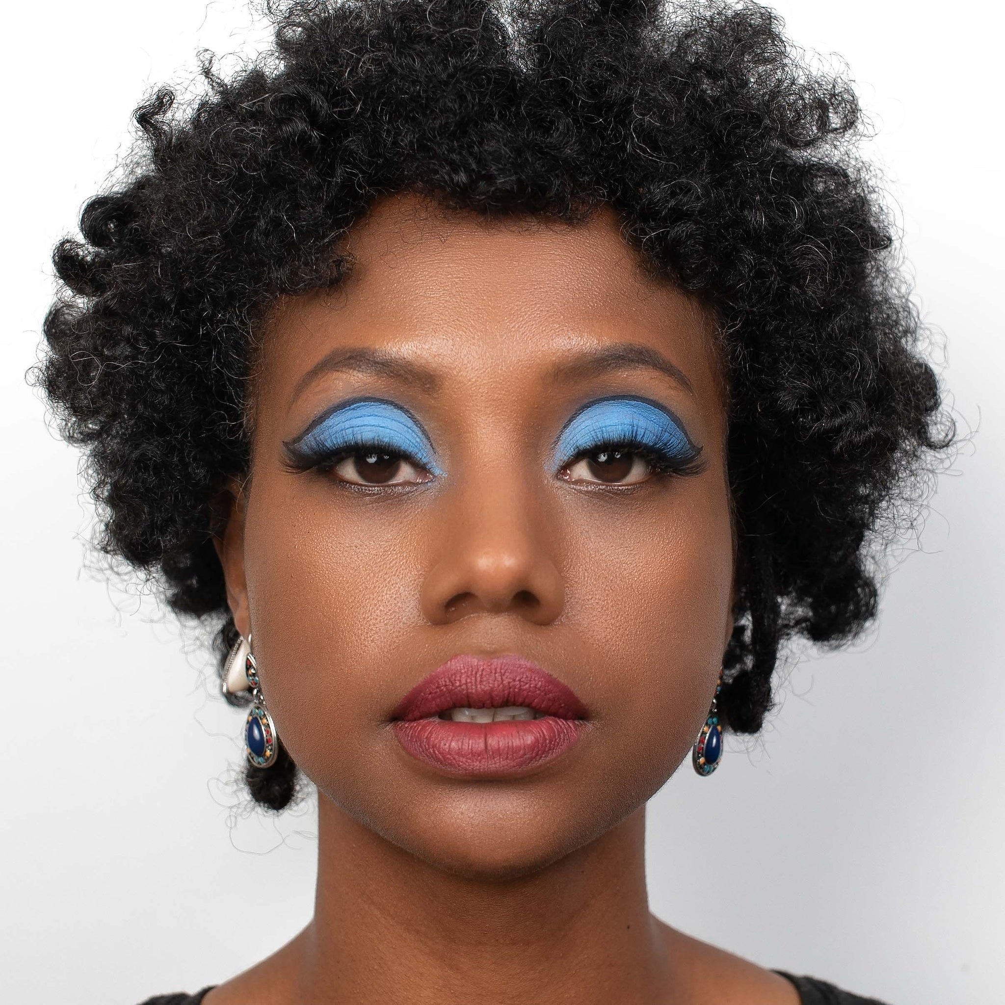 a model with a bright blue eyeshadow look taken from the matriarch palette