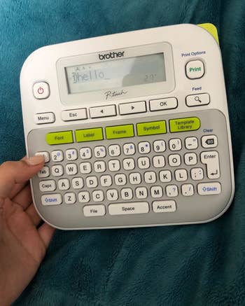 a reviewer holding the label maker