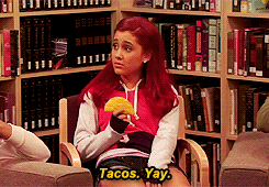 Ariana Grande eating a taco sadly while saying